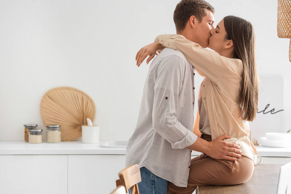 Young couple kissing in the living room